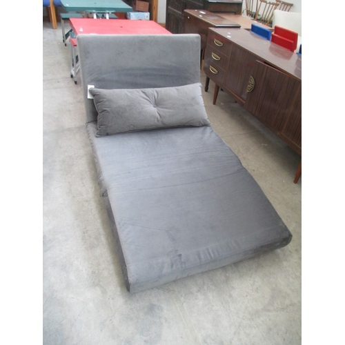 615 - A faux suede folding bed settee with cushion