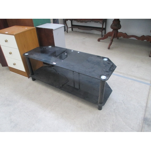 634 - A large 2 tier black glass TV stand