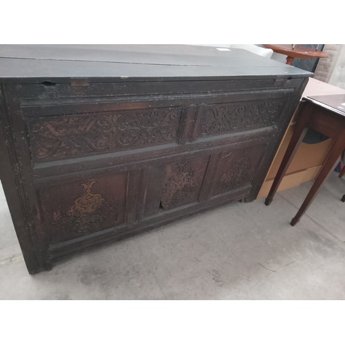 628 - A large Antique Oak lift top coffer with 2 x lower drawers and ornately carved rear panels