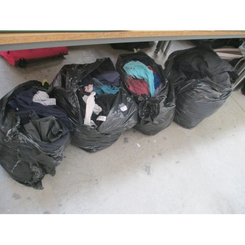 64 - Four bags of assorted clothing