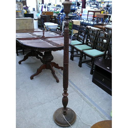 640 - A vintage ornately carved standard lamp