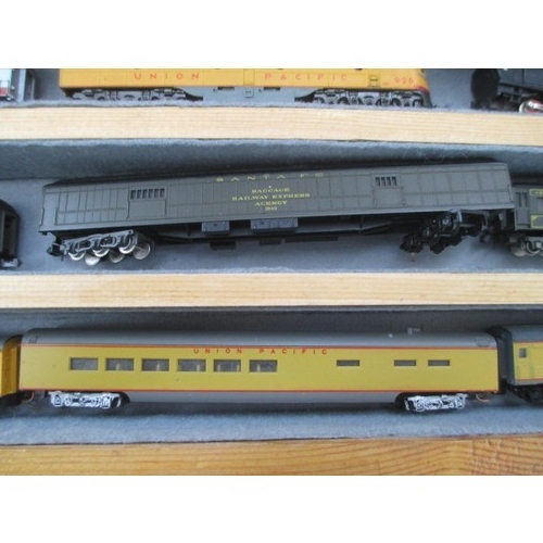 256 - Wooden display case containing miniature model rail locomotives and carriages