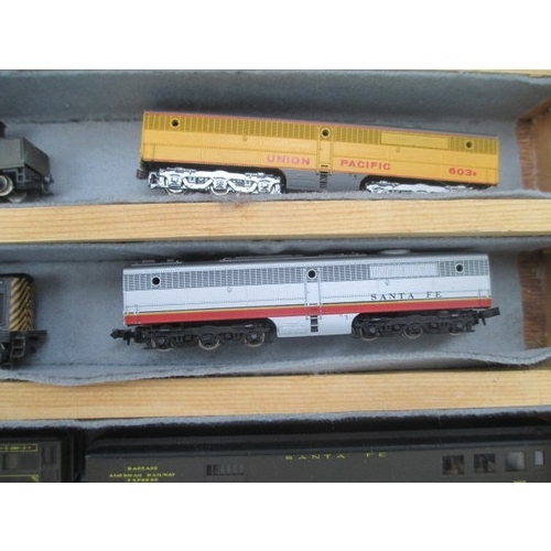 256 - Wooden display case containing miniature model rail locomotives and carriages