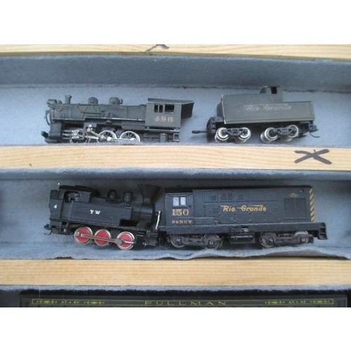 256 - Wooden display case containing miniature model rail locomotives and carriages