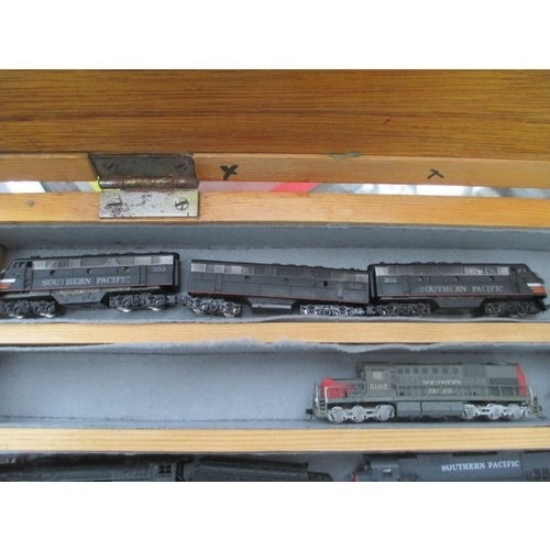 256 - Wooden display case containing miniature model rail locomotives and carriages