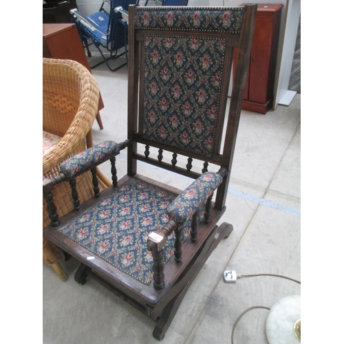 652 - A vintage spindle framed wooden rocking chair with upholstered seat pads