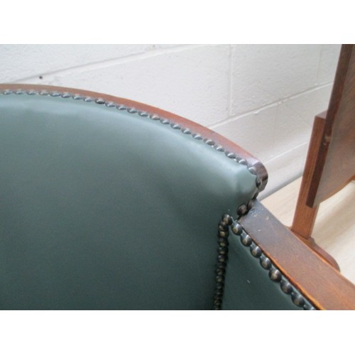 642 - A small vintage nursing tub chair with green leather cushion and panels