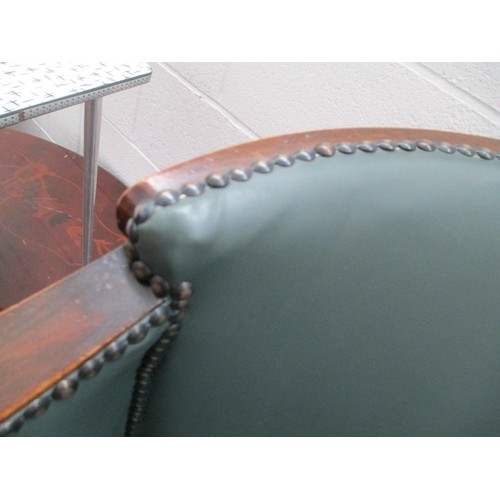 642 - A small vintage nursing tub chair with green leather cushion and panels