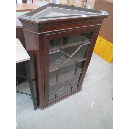 633 - A vintage mahogany wall hanging corner cabinet - one broken piece of glass