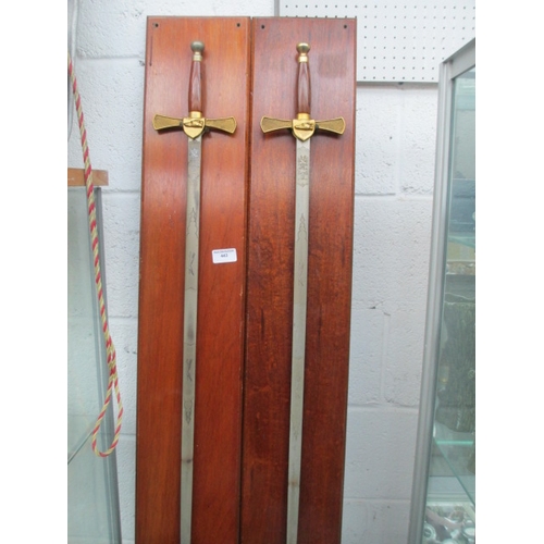 443 - Pair of ornamental swords on wooden backplates