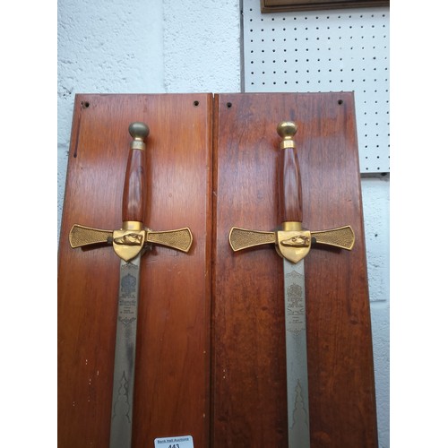 443 - Pair of ornamental swords on wooden backplates