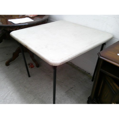 652 - A folding plastic topped table on metal frame