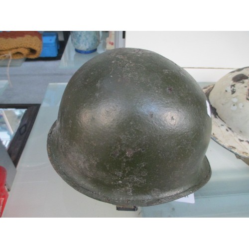 181 - Two vintage military helmets