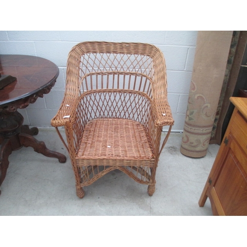 628 - A large wicker armchair