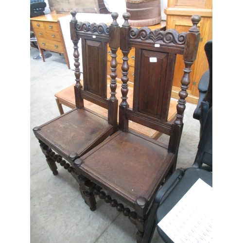 663 - A pair of vintage carved hall chairs with bobbin turned frames