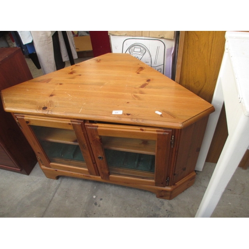 634 - A 2 door glazed pine corner TV stand cabinet