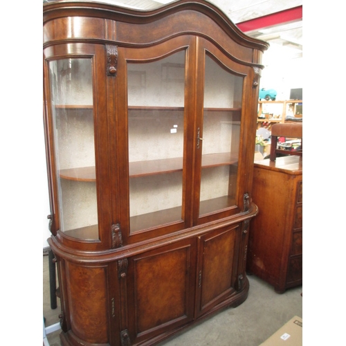 643 - A large vintage curved glass cabinet on 2 door cupboard base