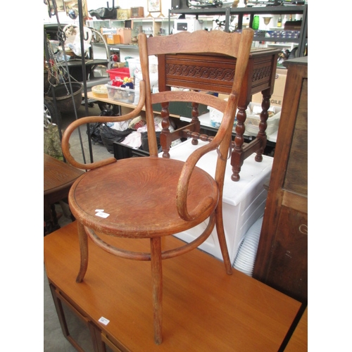 649 - A vintage Bentwood elbow chair with indented seat