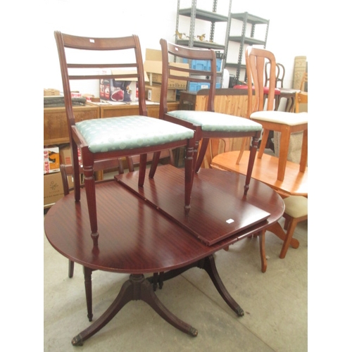 688 - A large extending twin pedestal dining table and 4 x matching chairs