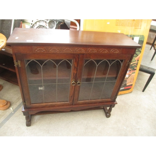 693 - A vintage carved oak lead glazed 2 door cabinet