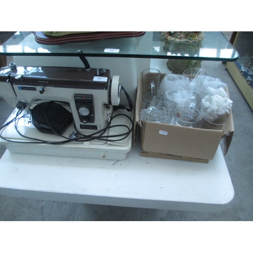 249 - New home sewing machine with case and box of glasses, sewing machine working