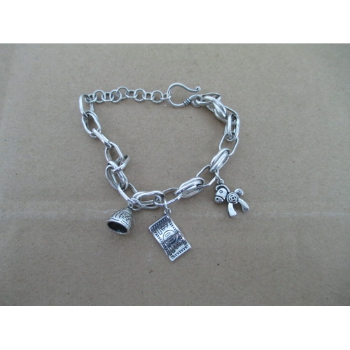 287 - Silver stamped charm bracelet with 3 charms