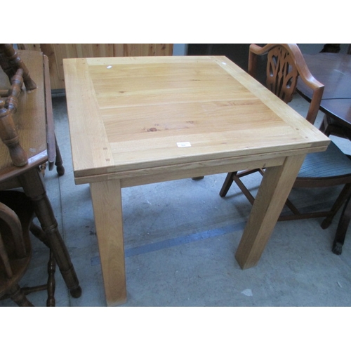 664 - A modern extending light oak dining table with folding top