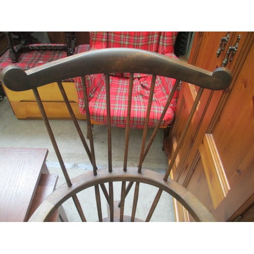 710 - A vintage wooden spindle back elbow chair with tapestry seat