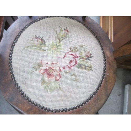 710 - A vintage wooden spindle back elbow chair with tapestry seat