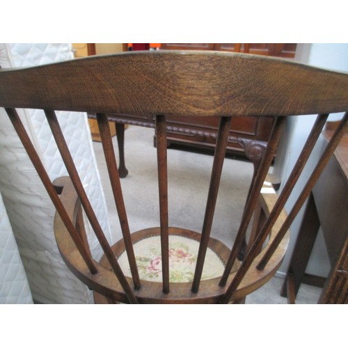 710 - A vintage wooden spindle back elbow chair with tapestry seat