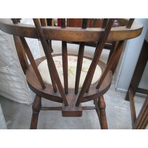 710 - A vintage wooden spindle back elbow chair with tapestry seat