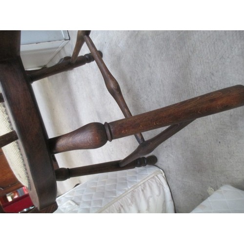 710 - A vintage wooden spindle back elbow chair with tapestry seat