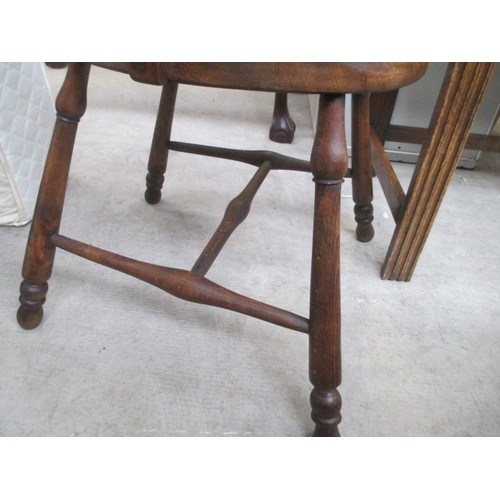 710 - A vintage wooden spindle back elbow chair with tapestry seat