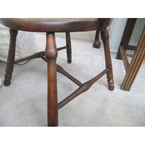 710 - A vintage wooden spindle back elbow chair with tapestry seat