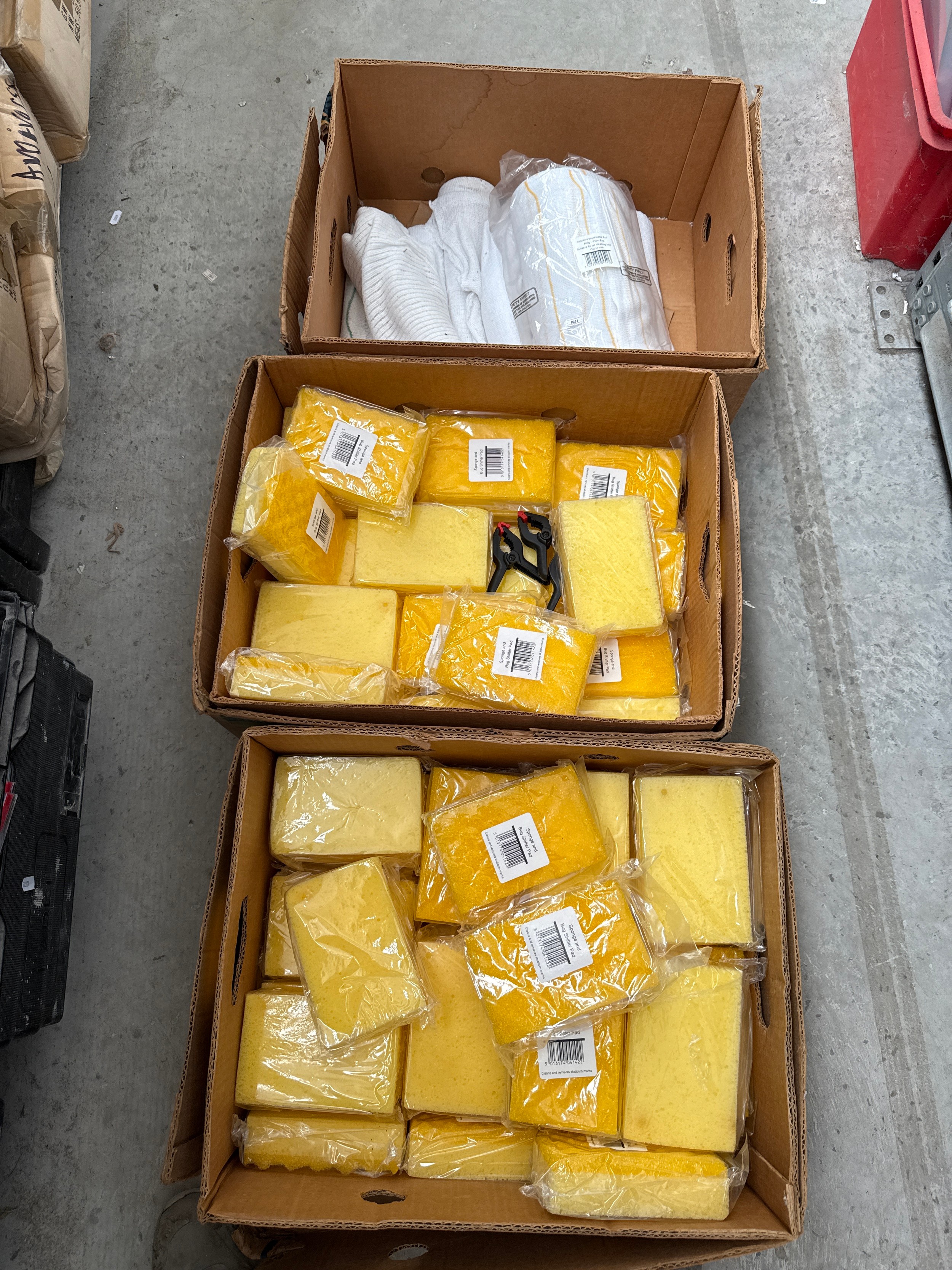 Two boxes of new sponges and box of cloths