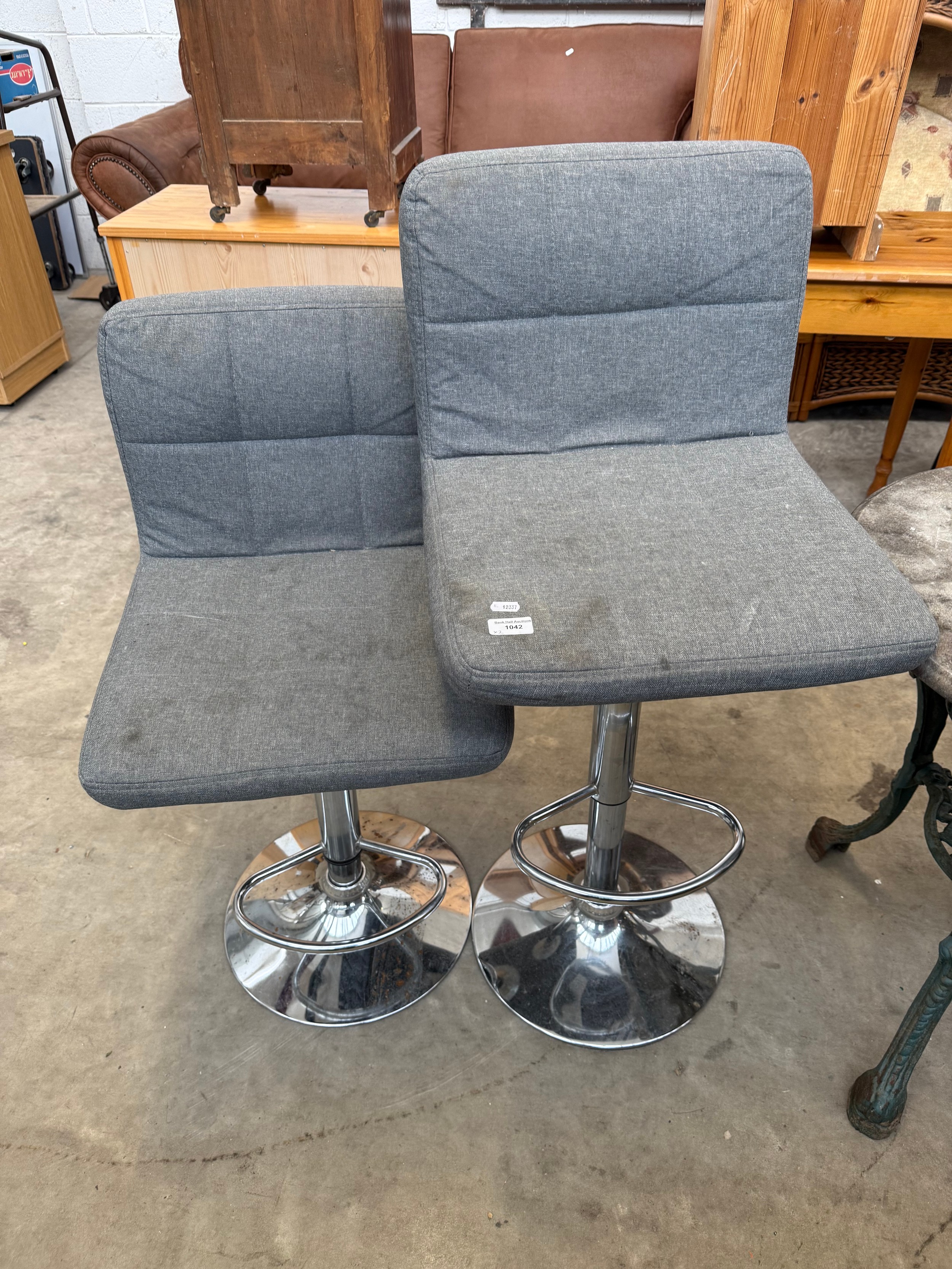 A pair of upholstered bar stools on chromed stands