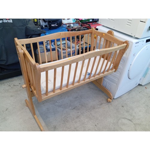 A wooden rocking cot