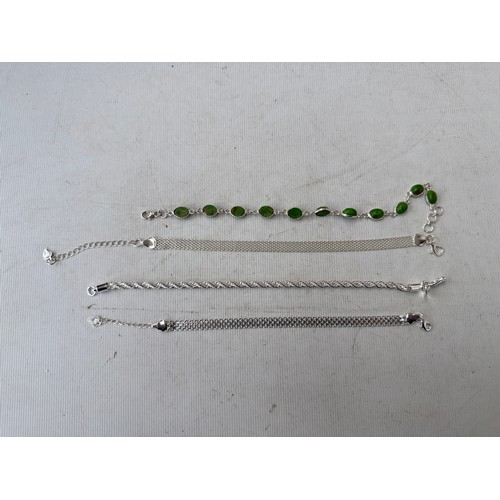 31 - Four silver stamped bracelets, 

weight 21.7 grams