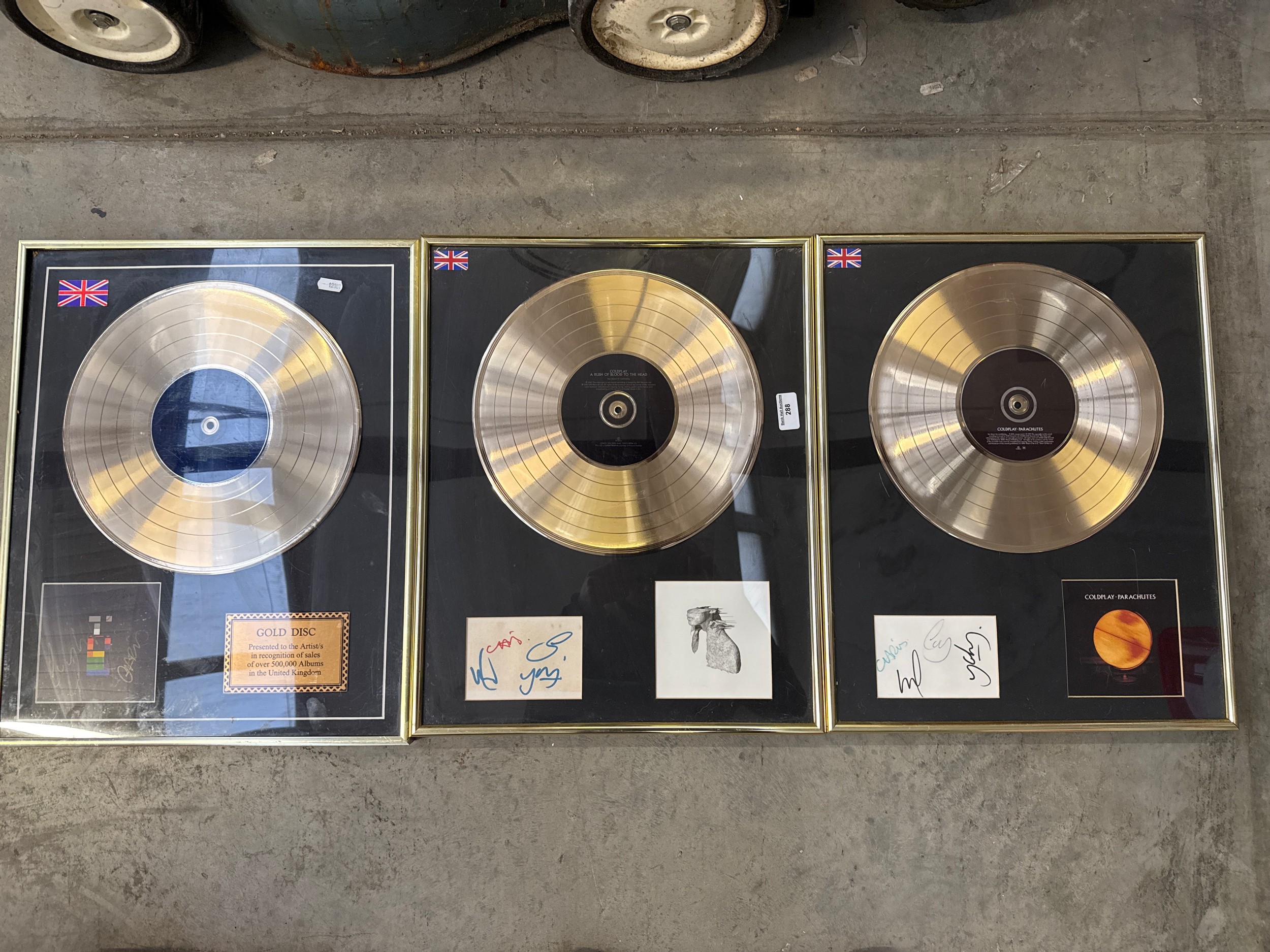 Three framed gold discs