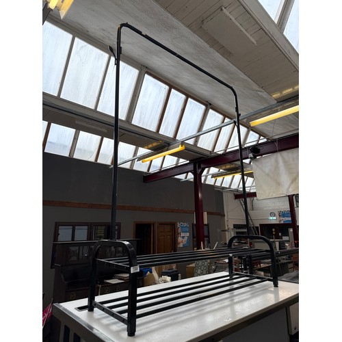 A 4ft wide metal hanging rail frame with shoe rack