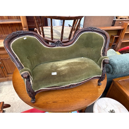 1037 - A small ornately carved Child's antique mahogany framed sofa