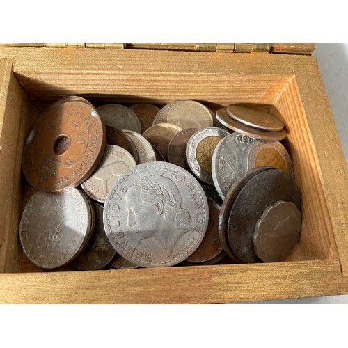 Small wooden box containing old coins