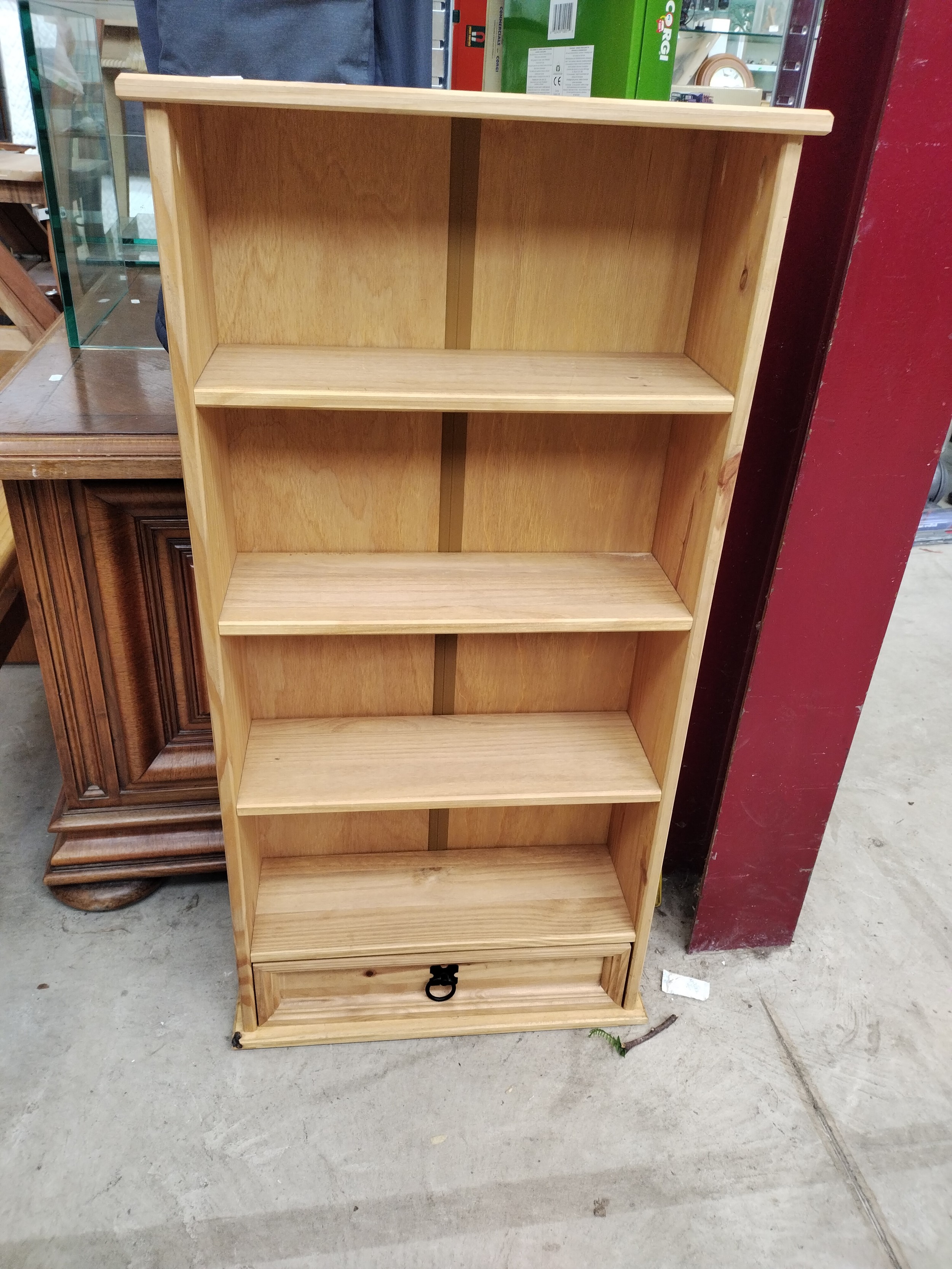A small retro open shelf unit with lower drawer