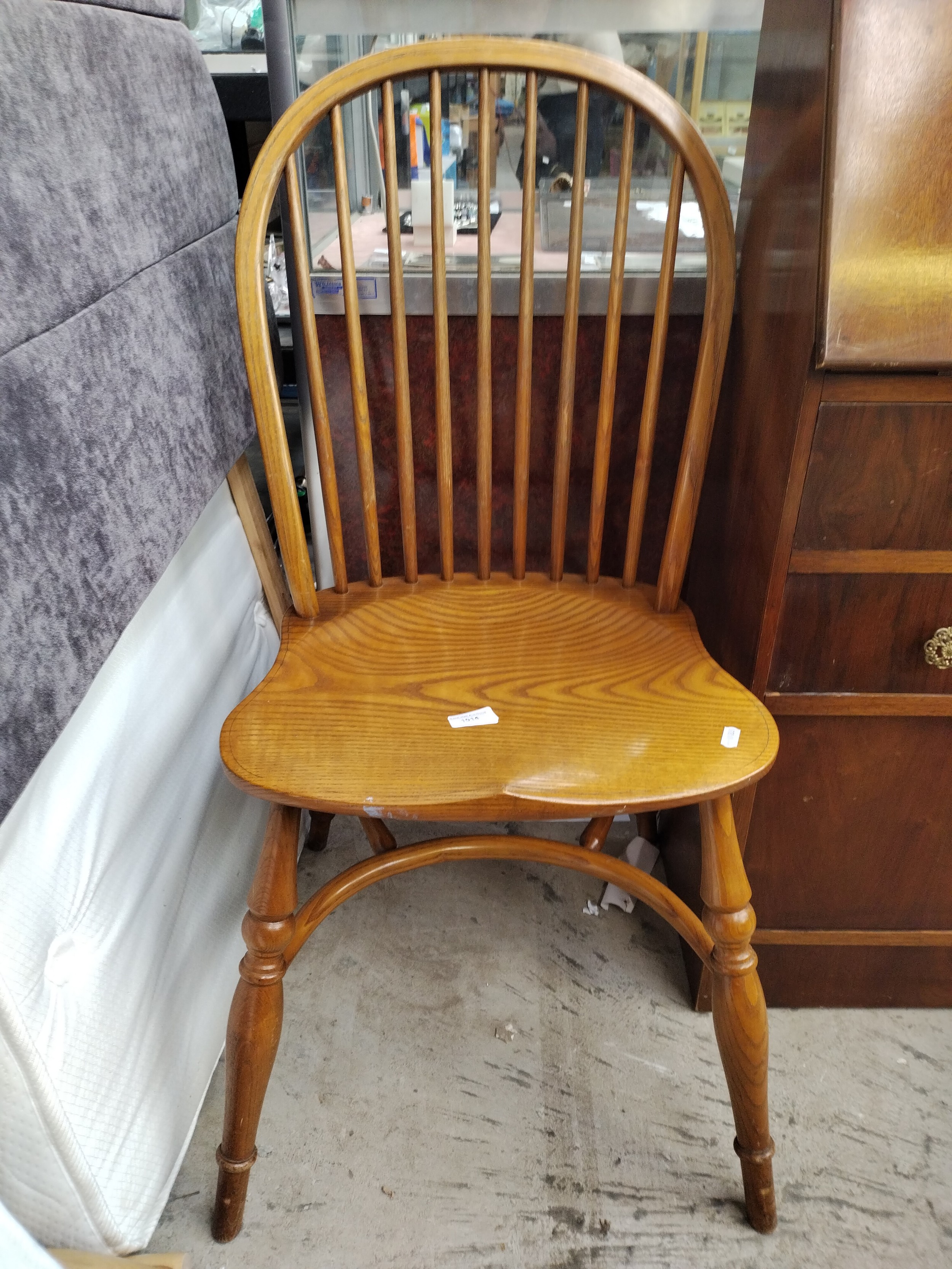 A vintage spindle backed Windsor chair with curved stretcher