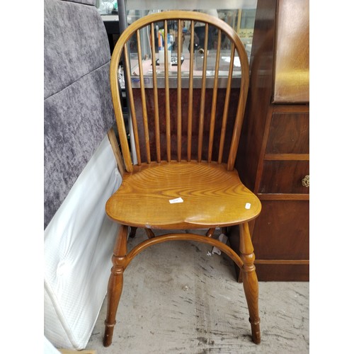 A vintage spindle backed Windsor chair with curved stretcher