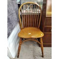 A vintage spindle backed Windsor chair with curved stretcher