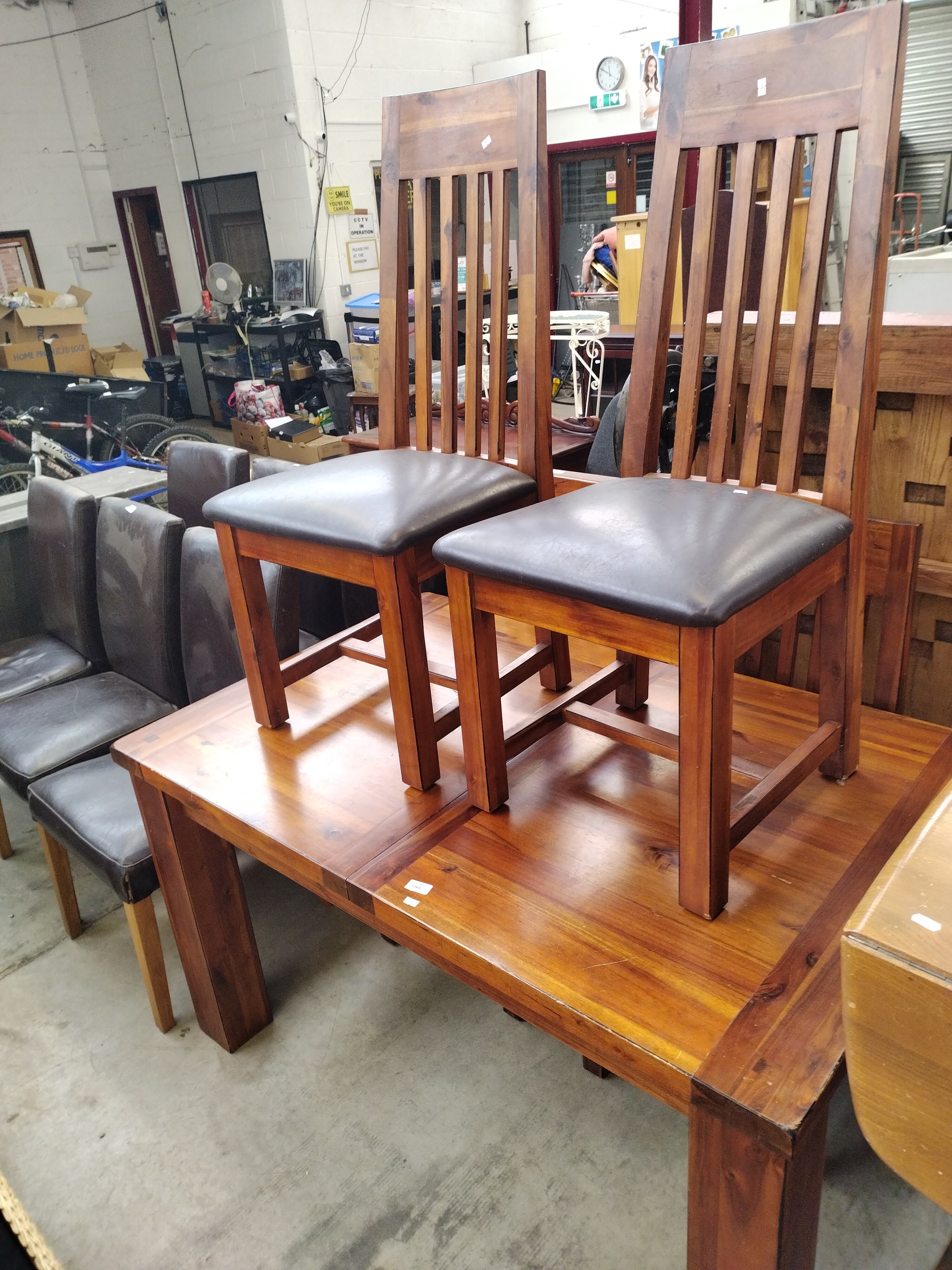 A large extending hardwood dining table and 4 x matching chairs