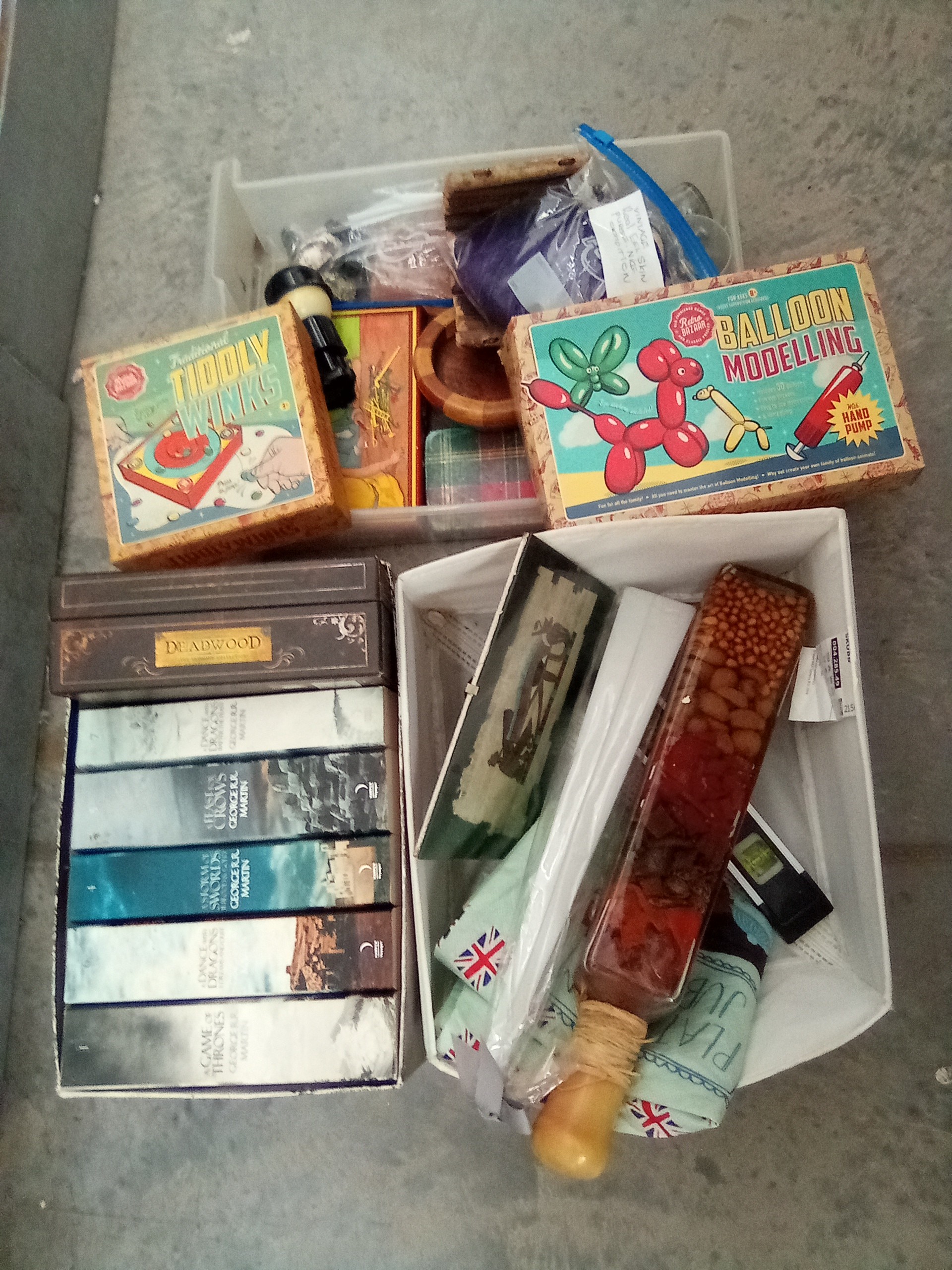 Lot inc Game of thrones books, Deadwood DVD set, eel skin purse, etc