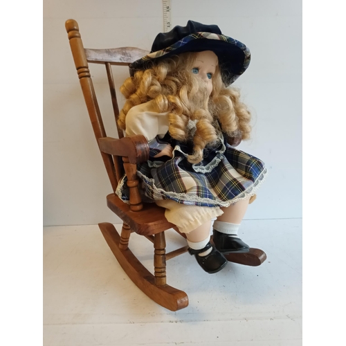 153 - Doll & a Wooden Rocking Chair