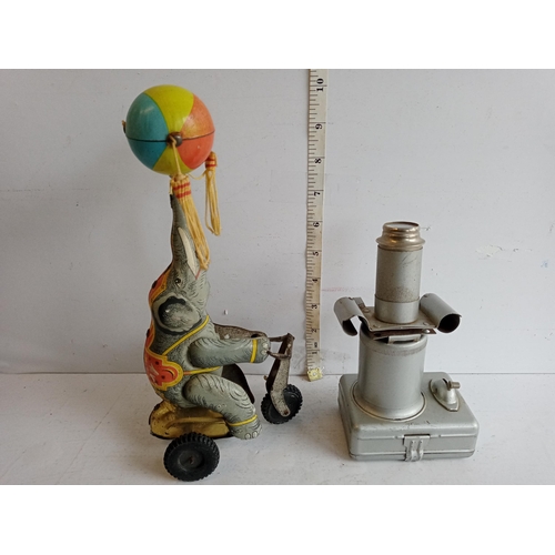 70 - Tin Plate Elephant Riding Bike & Tin Plate Child's Microscope